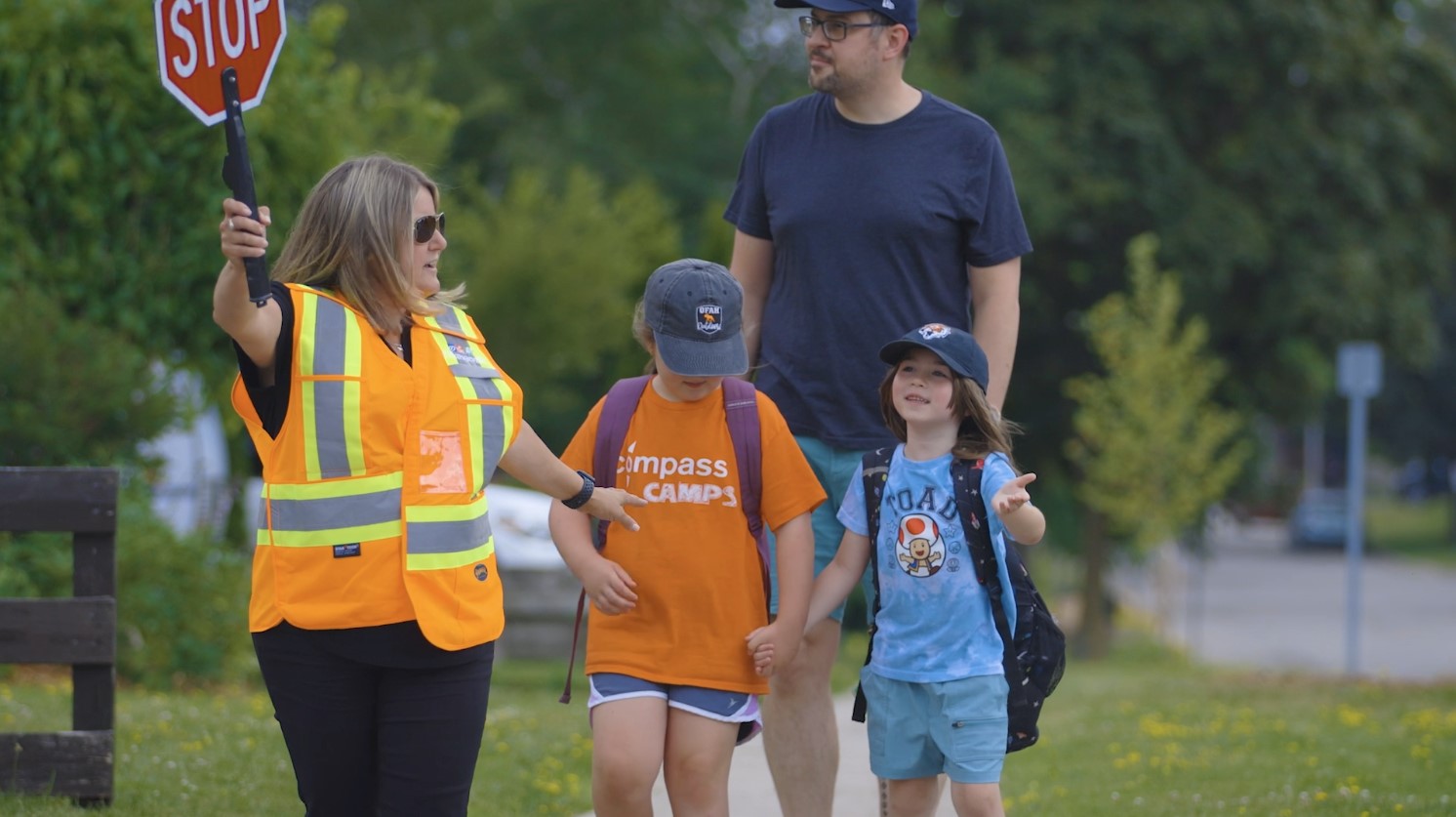 Crosswalks and crossing guards A crossing guard walking people across the stret