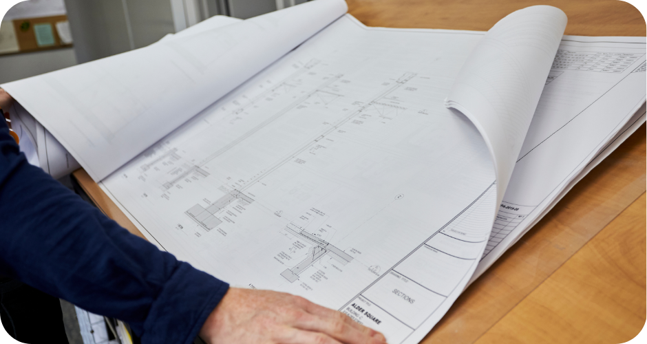 An image of planning blueprints open on a table